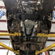 A view underneath the car, showing the new transmission and engine in place.